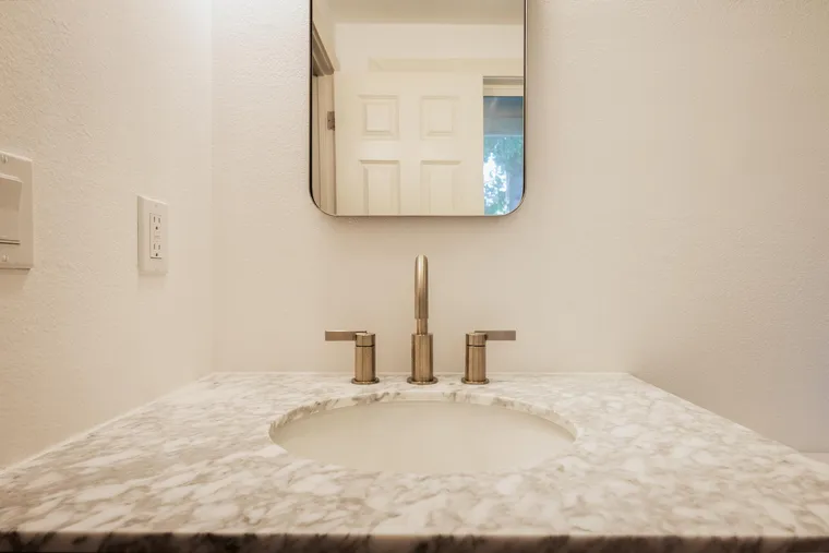 Marble vanity top with a brushed gold faucet