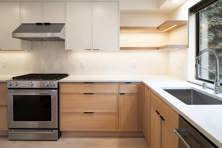 Range wall with oak cabinets and floating shelves