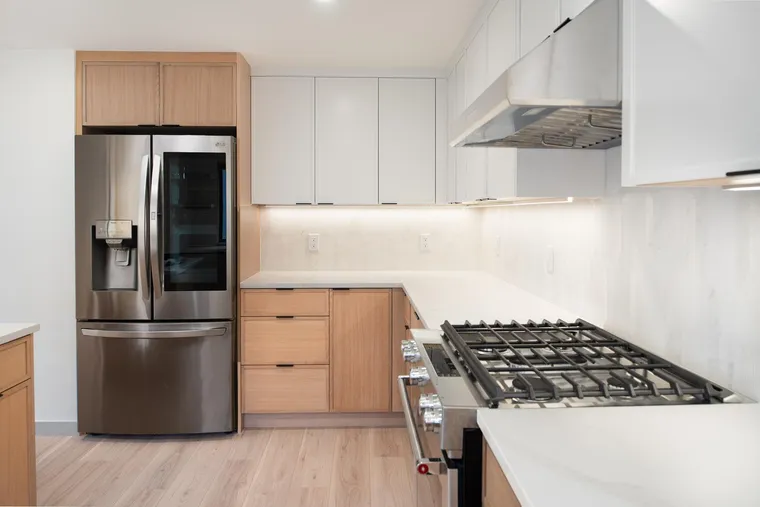 Oak lower cabinets, white uppers and a stainless gas range