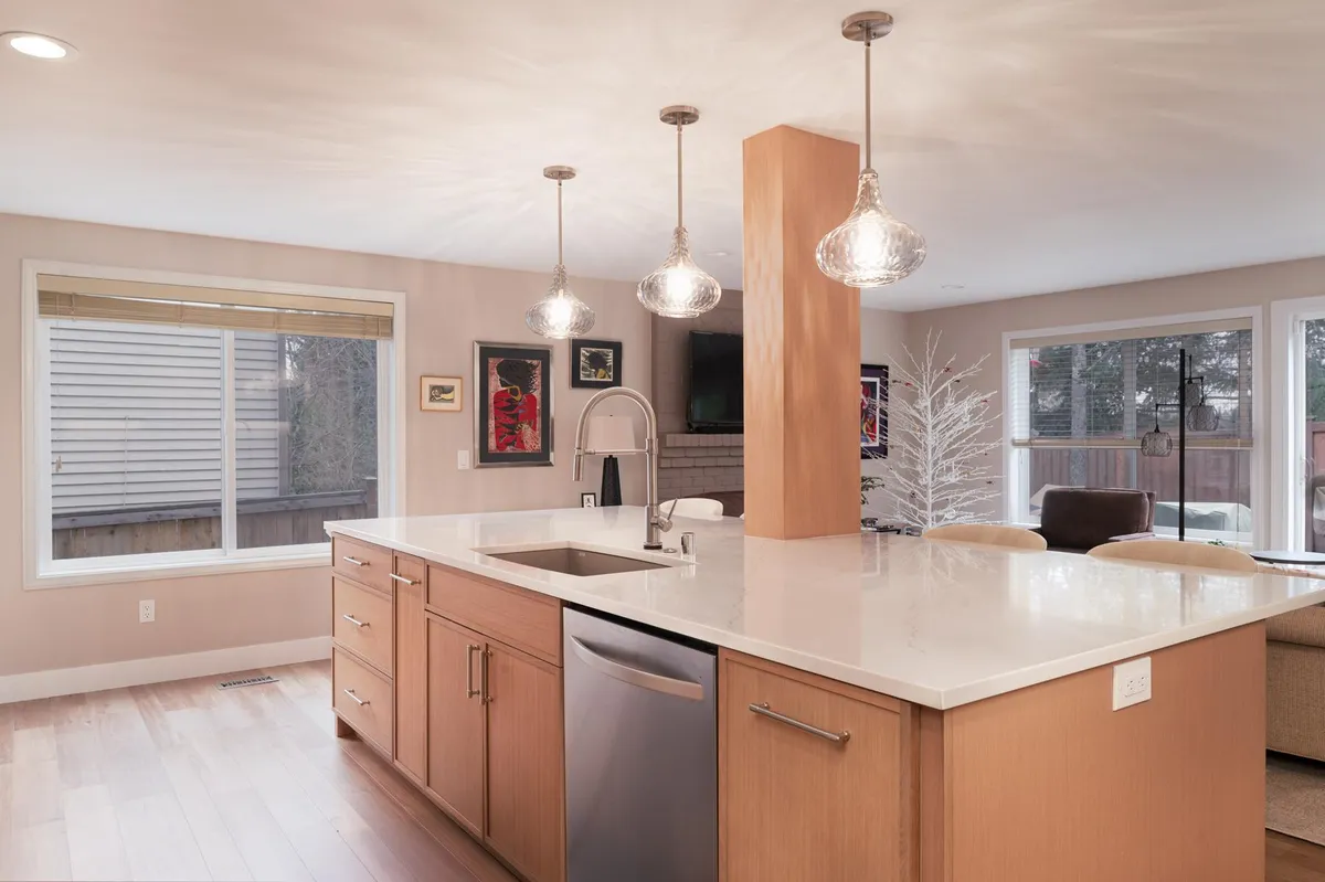 Light oak kitchen opening onto the living room
