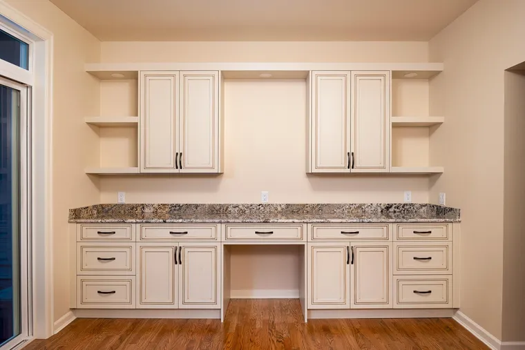 Built-in desk and cabinets in cream with a granite top