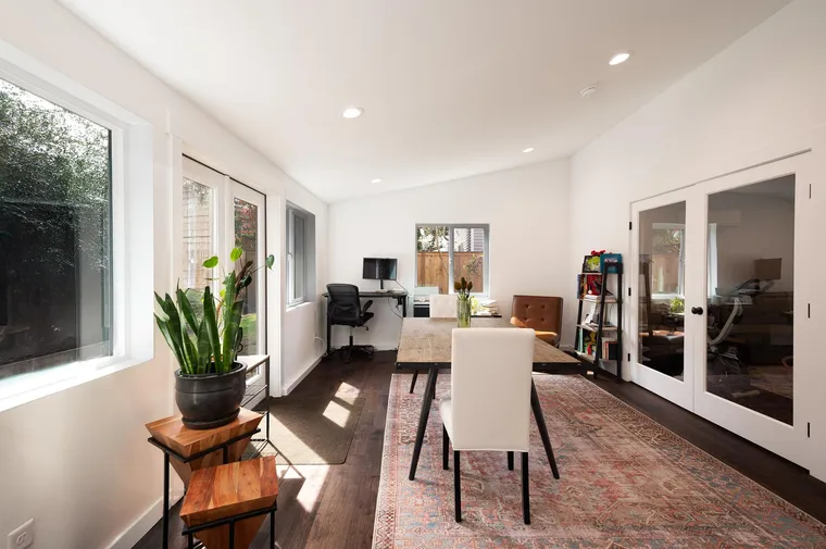 Addition with a vaulted ceiling, French doors and a dining table