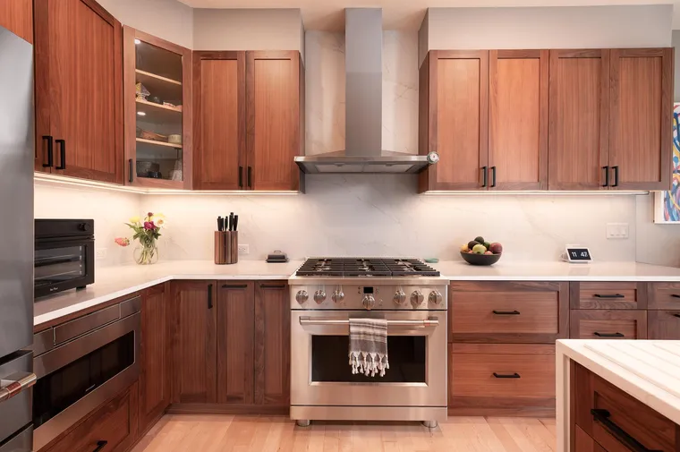 Walnut cabinetry around a professional range