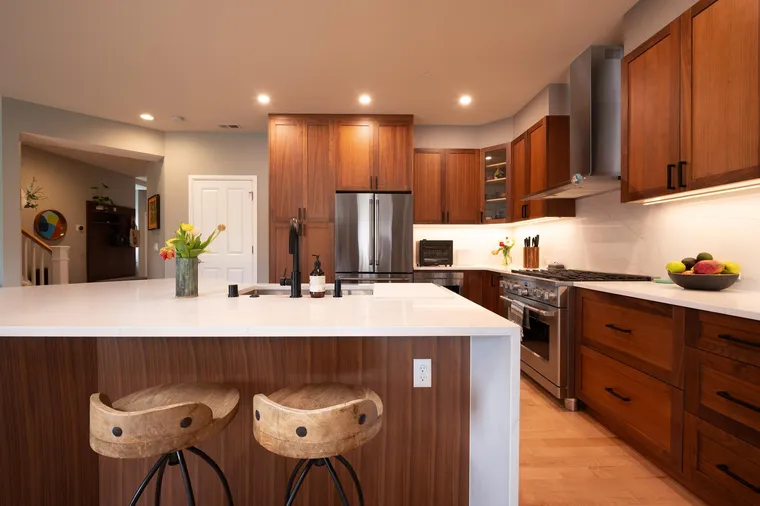 Waterfall island with saddle stools in a walnut kitchen