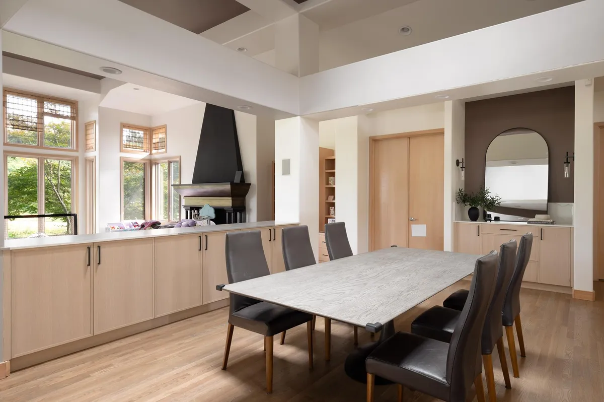 Dining table with a stone top beside the kitchen