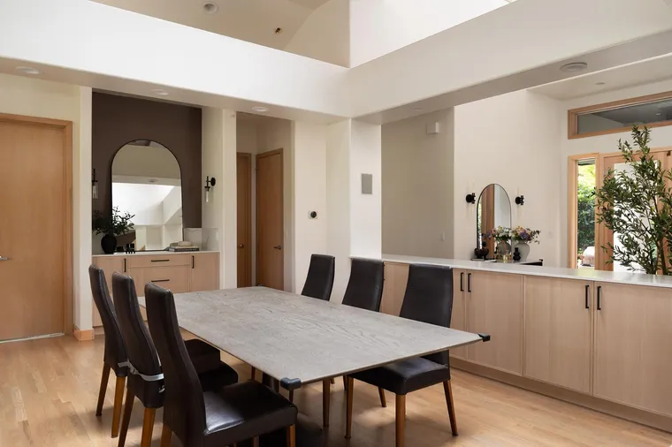 Dining table beside white oak built-ins