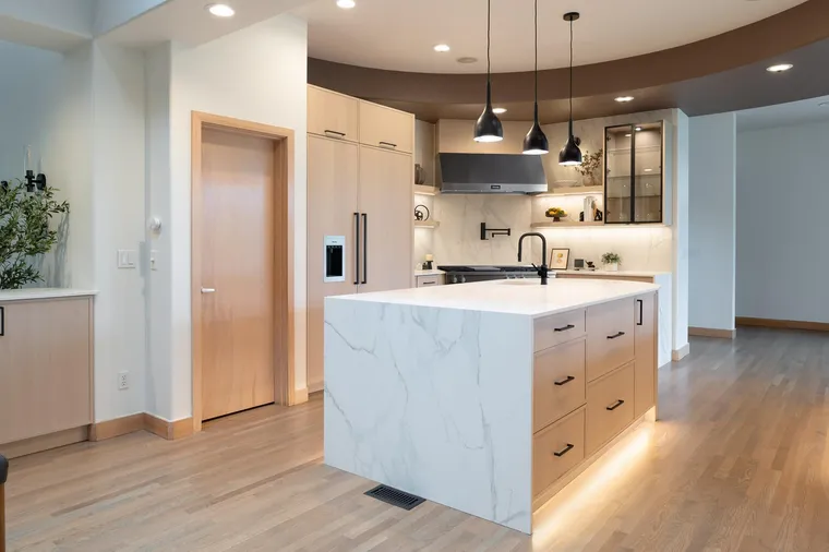 White oak kitchen with a marble-look waterfall island